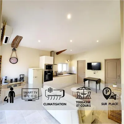 a room with a kitchen and a living room at Maison au calme - Clim - Wi-Fi - terrasse et cours in Salles-d'Aude