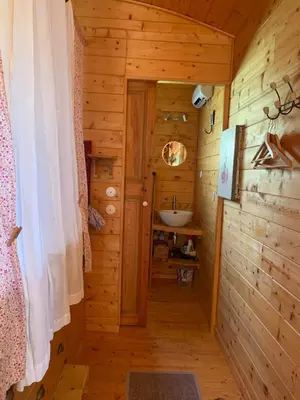 a bathroom with a sink in a log cabin at Roulotte et Nature in Mirepoix