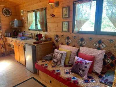 a living room with a couch with pillows on it at Roulotte et Nature in Mirepoix