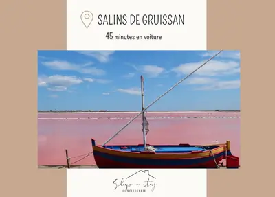 a boat sitting in the water with the words salivating be at La terrasse du Canal, appartement pour 5 personnes in La Redorte