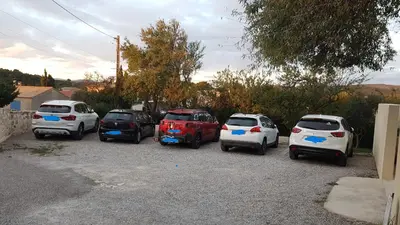 a group of cars parked in a parking lot at gite de l'ille, avec terrasse et parking privé in Peyriac-de-Mer