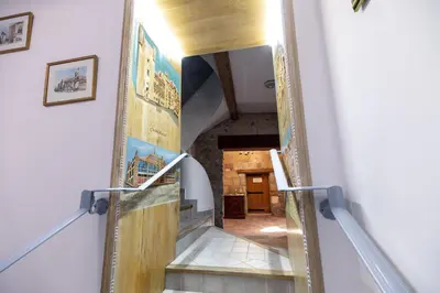 a staircase in a house with a view of a room at Chambre romantique du Couvent in Narbonne