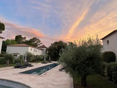 a swimming pool in a yard with a sunset at La Redorte 17 in La Redorte