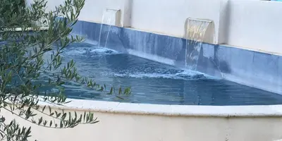 a water fountain in a pool in a building at La Redorte 29 in La Redorte
