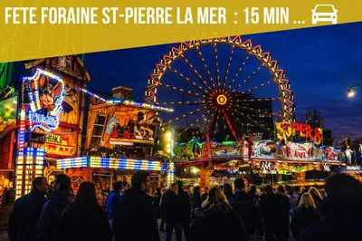 a crowd of people standing in front of a ferris wheel at Au cœur du village de Gruissan in Gruissan