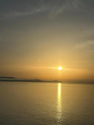 a sunset over a body of water at L'anguille du port clim jardin mer in Port-la-Nouvelle