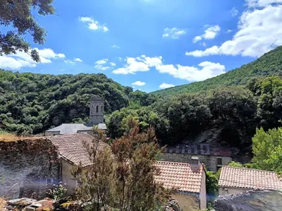 a view of a village with mountains in the background at Chambre b&b in Miraval-Cabardès