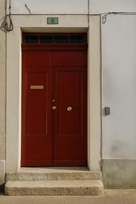 a red door in the side of a building at Appartement rénové avec 2 chambres et espace bien-être Lavelanet in Lavelanet