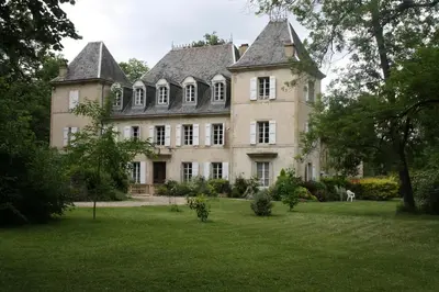 a large house with a large yard with green grass at Château Belle au Bois Dormant in Cambounet-sur-le-Sor