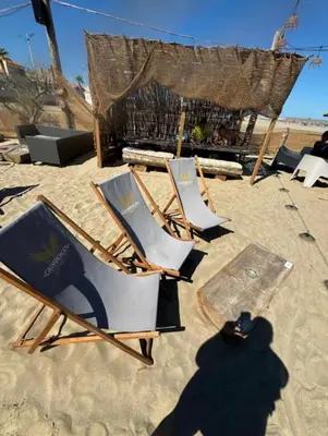 a group of lawn chairs on a beach at Charmant T2 à 1 min de la plage in Port-la-Nouvelle