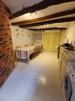 a kitchen with a table and chairs in a room at Maison entière Les Maisons de Gaia in Tuchan
