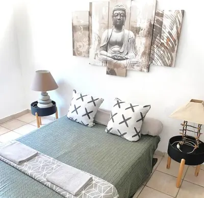 a room with a bed with a black and white picture on the wall at Appartement Centre Ville in Carcassonne