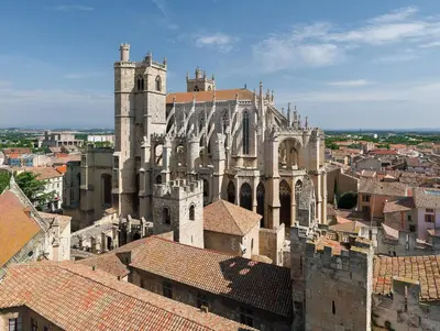 a view of a cathedral and roofs of buildings at Villa Valara in Narbonne