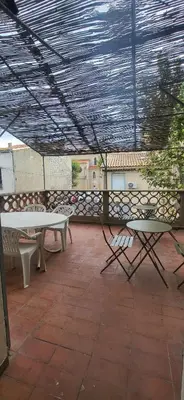 a patio with a table and chairs on a patio at Chambre 1 - avec grande terrasse in Port-la-Nouvelle