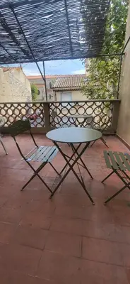 a table and two chairs on a patio at Chambre 2 - avec grande terrasse in Port-la-Nouvelle
