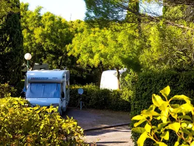 a stone house with a yellow roof and trees at Mobil-home avec Terrasse à Lézignan-Corbières, 6 personnes - API-1-52-736 in Lézignan-Corbières