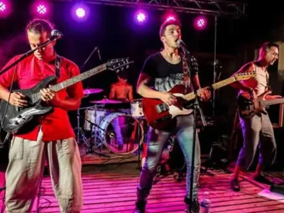 a group of people on a stage playing guitars at Mobil-home confortable avec terrasse pour 4 personnes à Sournia - API-1-52-622 in Sournia