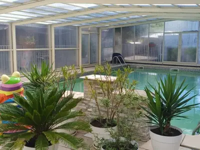 a swimming pool with plants in front of a building at Mobil-home avec Terrasse Accueillant 6 Pers - API-1-52-631 in Sournia