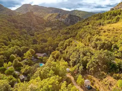 an aerial view of a forest with a house and mountains at Chalet 6 personnes avec Terrasse - API-1-52-233 in Fenouillet