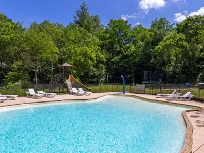 a swimming pool with chairs and a playground at Chalet 6 personnes avec Terrasse - API-1-52-233 in Fenouillet
