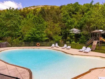 a swimming pool with chairs and a slide at Chalet 6 personnes avec Terrasse - API-1-52-233 in Fenouillet