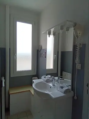 a bathroom with a sink and a mirror at Chambre la plage in Limoux