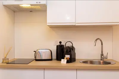 a kitchen counter with a toaster and a sink at Le Petit Capoine 3 - T2 en plein centre de Carcassonne in Carcassonne