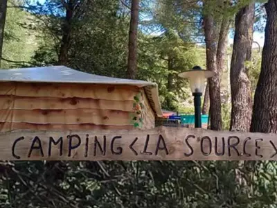 a sign in front of a tent in a park at Mobil-home confortable avec terrasse à Sournia - API-1-52-358 in Sournia