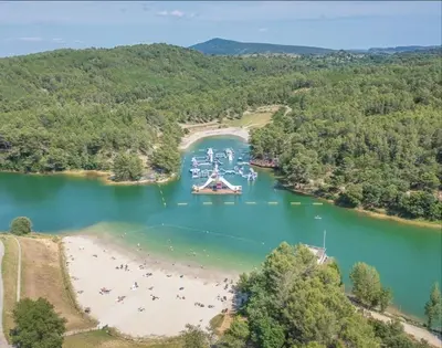 an aerial view of a beach and boats in a lake at Escale au pied de la cité in Carcassonne