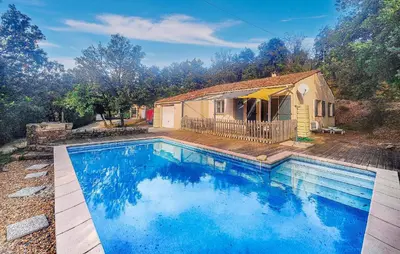 a large swimming pool in front of a house at Pause Nature Avec Piscine in Ferrières-Poussarou