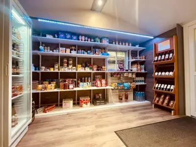 a store aisle with a lot of products on shelves at Bungalow 3 Pièces avec Terrasse - API-1-52-888 in Camon