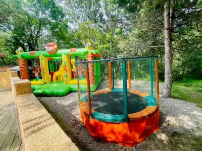a playground with a play equipment in a park at Chalet cosy avec terrasse pour 4 personnes - API-1-52-919 in Camon