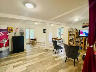 a living room with chairs and a table and a television at Chalet Confort 6 Pers - Terrasse - API-1-52-1032 in Camon