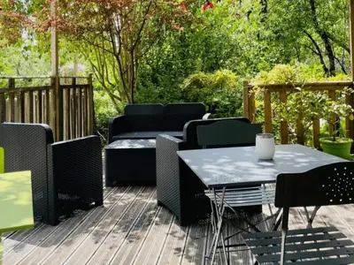 a patio with a table and chairs on a deck at Chalet de 26m² avec Terrasse pour 4 Personnes - API-1-52-1070 in Camon
