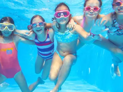 a group of girls swimming in a swimming pool at Chalet de 26m² avec Terrasse pour 4 Personnes - API-1-52-1070 in Camon