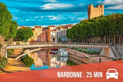 a bridge over a river in a city at La Sigeannaise belle maison près des plages in Sigean