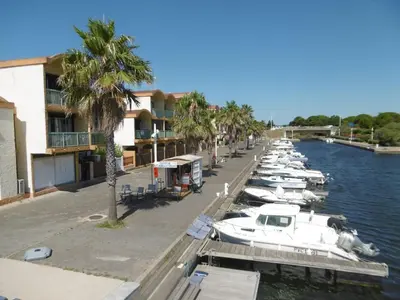a group of boats docked at a marina in the water at Gruissan - T2 cosy 4 pers - Proche port - FR-1-796-95 in Gruissan