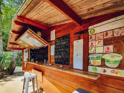 a restaurant with a bar with a chalkboard on the wall at Mobil home 6 pers avec terrasse à Fenouillet - API-1-52-314 in Fenouillet