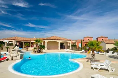 a swimming pool in front of a resort at P Minervois G N02 Villa 3P4 in Homps