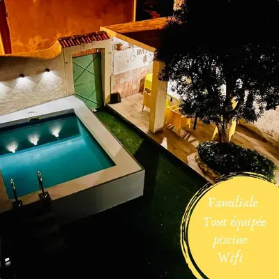 a pool in the backyard of a house at Maison de village avec piscine 8 personnes in Ouveillan