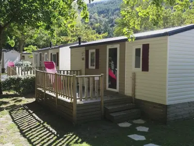 a tiny house with a porch and a deck at Mobil-home 6 Pers avec Terrasse à Axat - API-1-52-973 in Axat