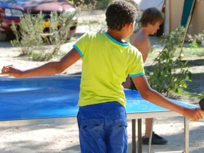 a young boy is playing with a frisbee at Mobil-home avec Terrasse à Axat - API-1-52-1004 in Axat