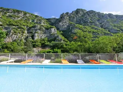a group of chairs sitting next to a swimming pool at Mobil-home 2 pers. avec terrasse à Axat - API-1-52-1188 in Axat