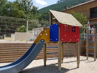 a playground with a slide and a play structure at Mobil home avec Terrasse, 2 Chambres, 5 Personnes - API-1-52-1140 in Axat