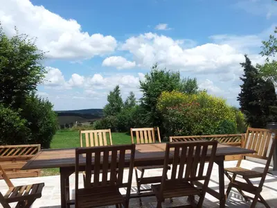 a wooden table with four chairs around it at Holiday Home Gemütliches Ferienhaus in Villautou by Interhome in Villautou