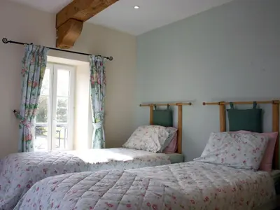 two beds in a bedroom with a window at Holiday Home Haus für 6 Personen und 8 Kinder in Villautou by Interhome in Villautou