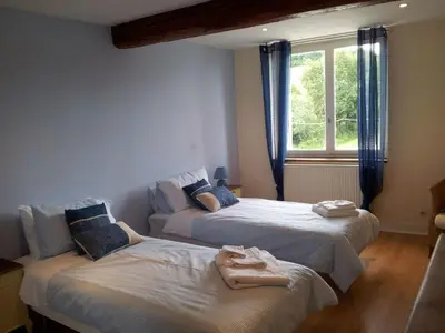 two beds in a room with a window at Holiday Home Schönes Ferienhaus mit Pool in Villautou by Interhome in Villautou