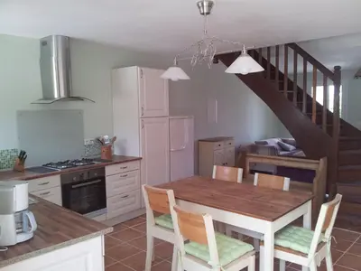 a kitchen with a dining room table and a staircase at Holiday Home Schönes Ferienhaus mit Pool in Villautou by Interhome in Villautou