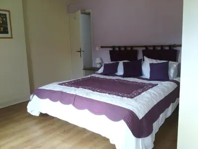 a bedroom with a large bed with purple pillows at Holiday Home Schönes Ferienhaus mit Pool in Villautou by Interhome in Villautou