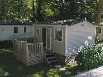 a small house with a porch and a door at Mobil home 21m² avec terrasse à Axat - API-1-52-1082 in Axat